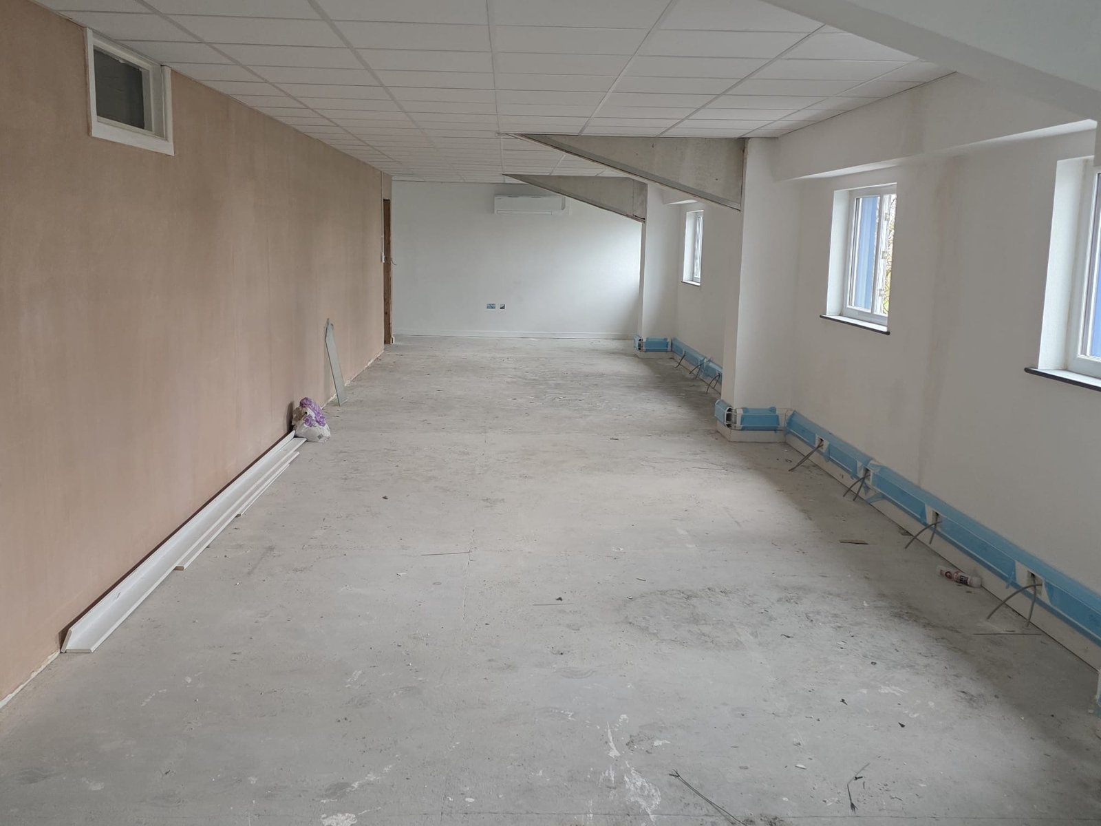 Boarded walls and suspended grid ceiling in a commercial interior