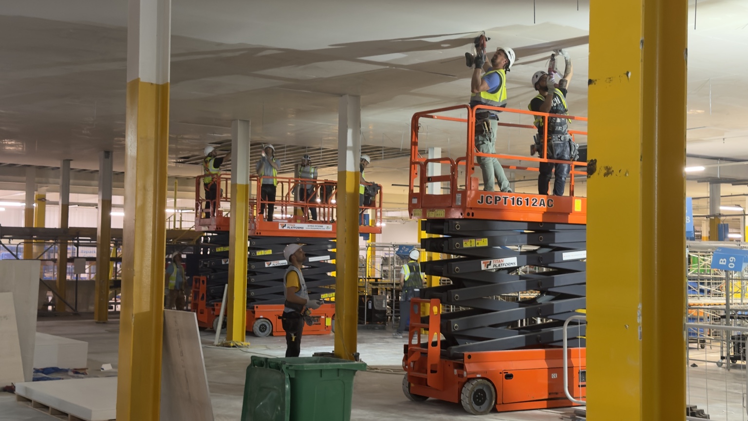 TGM operatives installing a commercial ceiling using access platforms