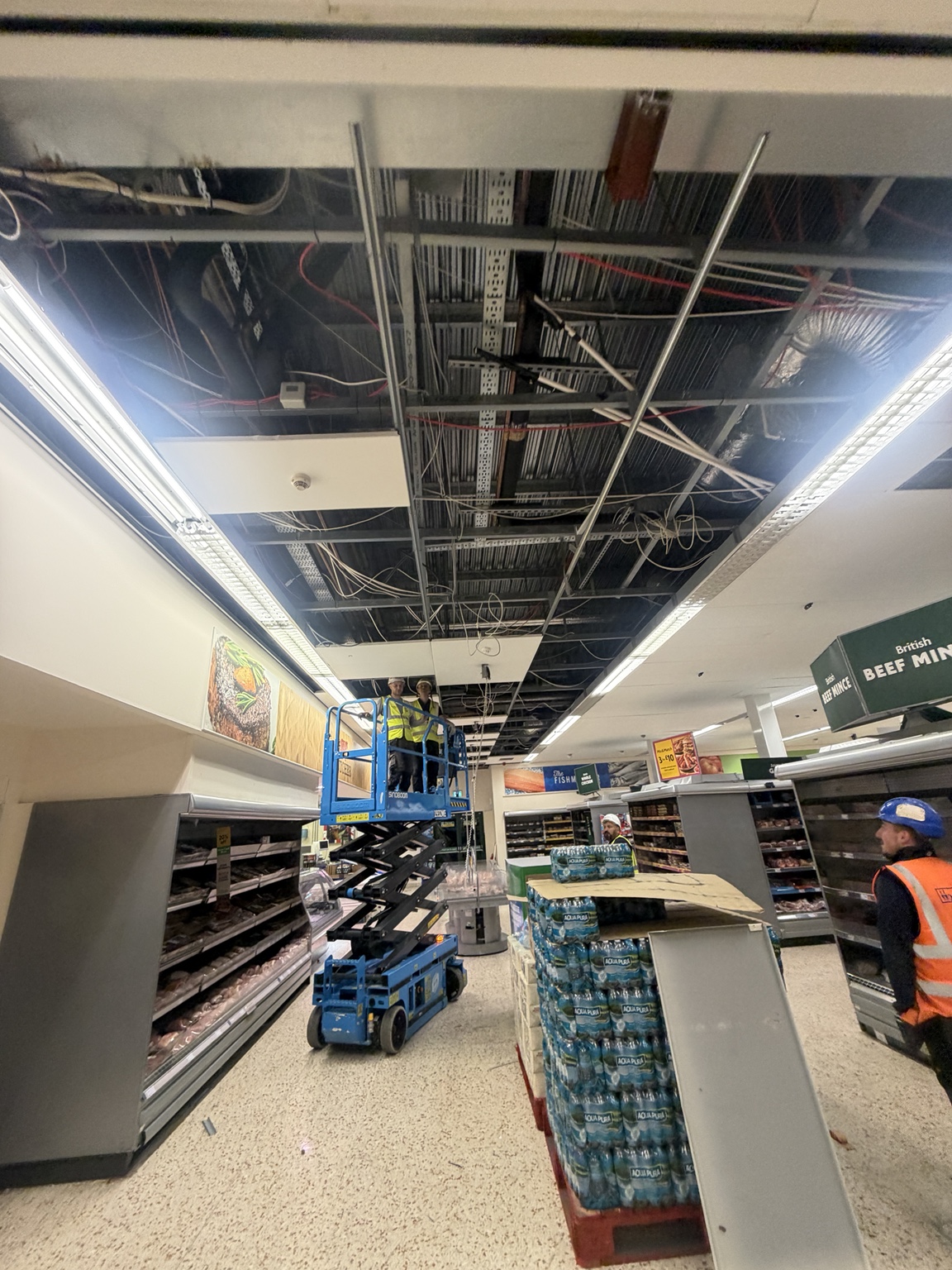 Ceiling works in progress within a retail interior