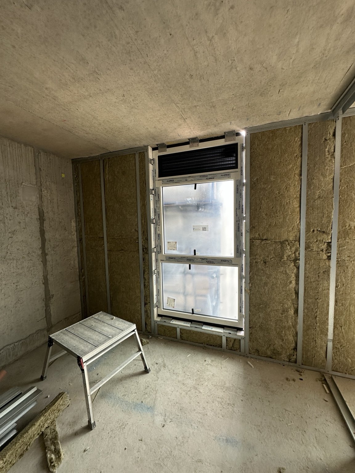 Insulated wall framing around a window opening