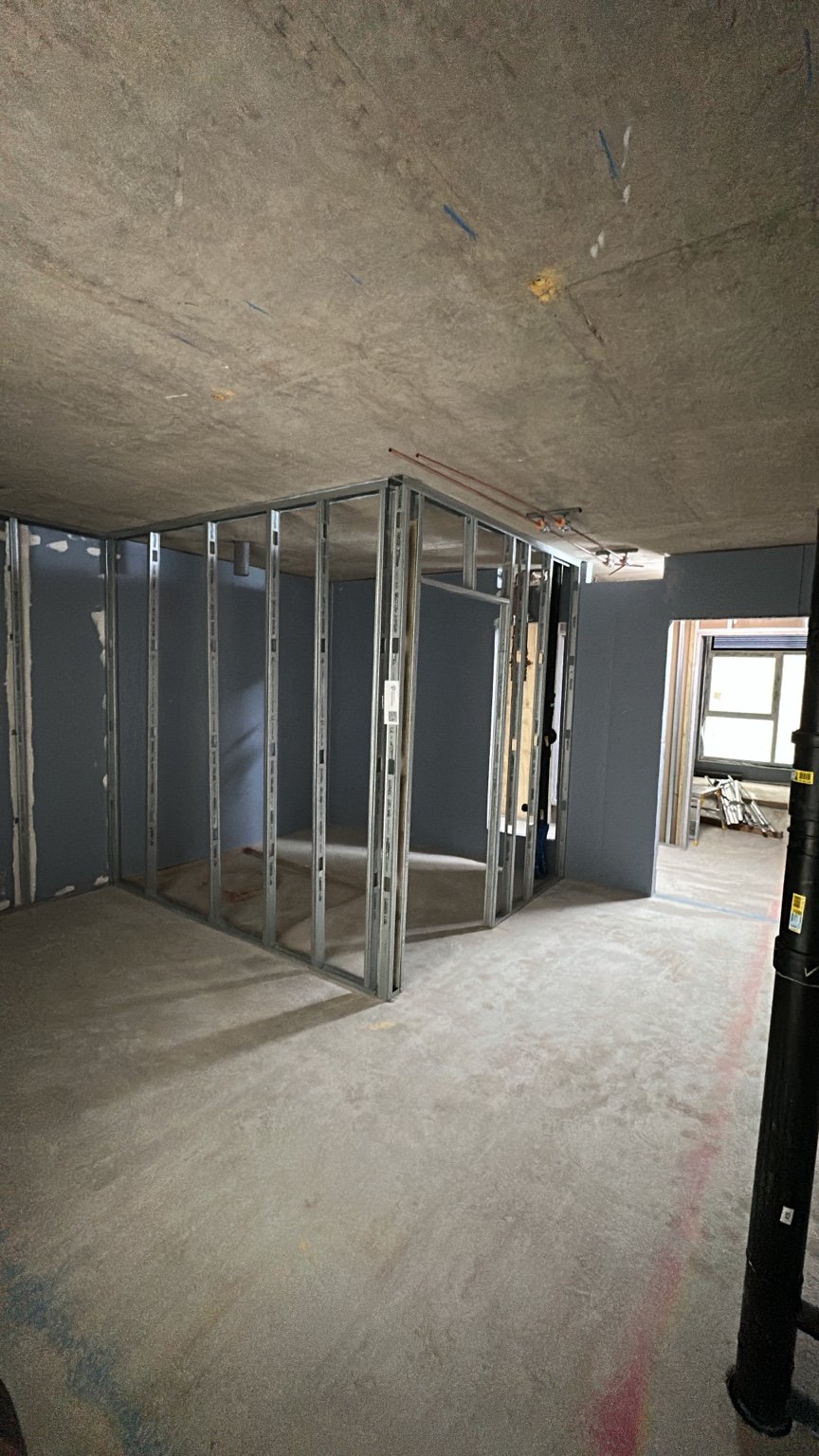 Metal stud partitions forming rooms within an interior