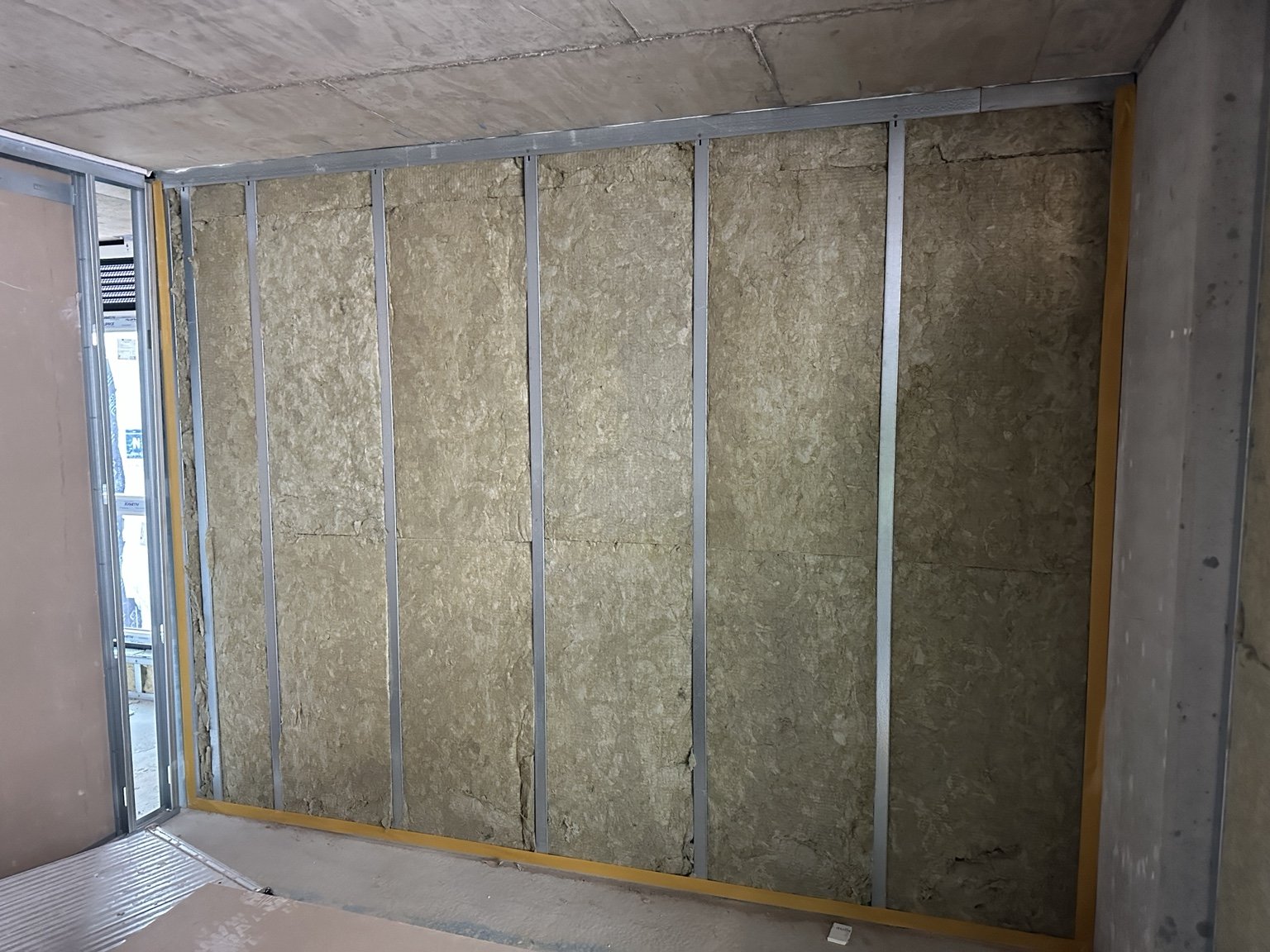 Mineral wool insulation within metal stud wall framing
